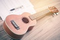 Ukulele and musical paper notes Royalty Free Stock Photo
