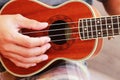 Ukulele players play a small classic brown beautiful,Close up