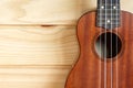 Ukulele on wooden background.