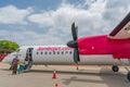 Bombardier Aircraft at Diani Beach, Ukunda Airport with cloudy blue Sky and People going inside the Plane