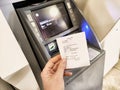 Ulaanbaatar, Mongolia - October 20, 2024: Using an ATM in Ulaanbaatar, Mongolia for cash withdrawal and receipt