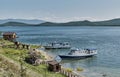 Zmeyevaya bay, Chivyrkuisky bay of Baikal, Russia. Boats bringing tourists to visit thermal spring Royalty Free Stock Photo