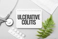 Ulcerative Colitis word on notebook,stethoscope and green plant Royalty Free Stock Photo