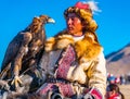 The Golden Eagle Hunter on horseback looking at the well trained eagle