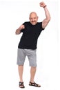 Ull portrait of a bald man with shorts and fist up on white background Royalty Free Stock Photo