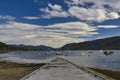 Ullapool jetty, sailing boats on sea and mountains on summer day Royalty Free Stock Photo