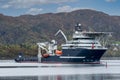 ULSTEINVIK, NORWAY - 2020 MAY 07. Multipurpose Offshore Vessel with big offshore crane inside the Norwegian fjord Royalty Free Stock Photo