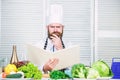 Ultimate cooking guide step by step. Book recipes copy space. Man chef in hat and apron read book. Culinary recipes book