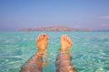Ultimate holiday feeling, feet in clear blue water at a paradise and tropical location