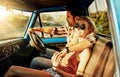 This is the ultimate road trip. a young couple out on a road trip with their truck.