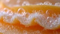 Ultra-close-up view of water droplets on peach skin, highlighting the delicate fuzz and vibrant orange hues