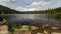 Ultra high definition 4k time lapse movie of moving clouds and people kayaking and boating in Trillium Lake Clackamas County