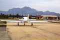 Ultra light aircraft at the airport against the backdrop of the mountains. View from afar