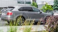 Ultra luxury crossover SUV Bentley Bentayga in gray color. Rear side view