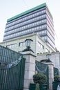 Ultra modern beautiful gray building with sculptured gates, and lamp lights