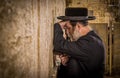 The ultra-orthodox Jewish man (haredi) praying with Tora in hand at Western wall (Wailing Wall) at Jerusalem.