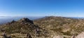 Ultra panoramic view at the Caramulo mountains, with wind turbines and blue sky, Serra da Estrela mountains as background