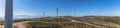 Ultra panoramic view at the Caramulo mountains, with wind turbines and blue sky, Serra da Estrela mountains as background, in