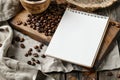 Blank Notepad and Coffee Beans on Wooden Background Royalty Free Stock Photo