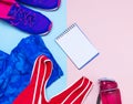 Ultra violet female sneakers, pink top blue sporting leggings and water bottle on pastel pink background flat lay top view with co Royalty Free Stock Photo