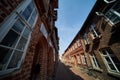 Ultra wide angle shot of a narrow alley of red brick houses in the interior of a northern German old town Royalty Free Stock Photo