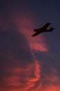 Ultralight aircraft flie over red flaming cloudscape Royalty Free Stock Photo