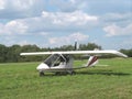 Ultralight aircraft in grassy field Royalty Free Stock Photo