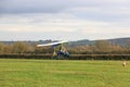Ultralight airplane landing on a grass strip Royalty Free Stock Photo