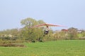 Ultralight airplane taking off from a grass strip Royalty Free Stock Photo