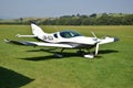 Ultralight double-seat propeller-driven PS-28 Cruiser airplane stands on grass landing strip in small country airport