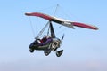 Ultralight airplane flying in a blue sky Royalty Free Stock Photo