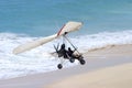 Ultralight Flying coming in for a landing on the beach Royalty Free Stock Photo