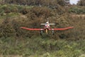 Ultralight plane flying in an airfield