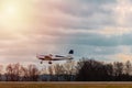 Ultralight plane take off from runway on airports with cloud sky and sun Royalty Free Stock Photo