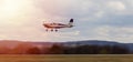Ultralight plane take off from runway on airports with cloud sky and sun. Panning photo Royalty Free Stock Photo