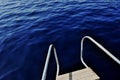 Ultramarine blue water viewed from pulpit of yacht.