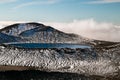 Ultramarine deep Blue Lake under the top of the mountains in high magnitude, above clouds, New Zealand, Tongariro National Park