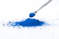 ultramarine pigment, dry paint on a white background, macro Royalty Free Stock Photo