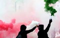 Ultras fans with smoke red white and green dressed in black