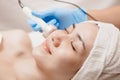 Ultrasonic facial skin massage with women happy face skincare tightening in beauty salon spa Royalty Free Stock Photo