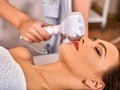 Ultrasonic facial treatment on ultrasound face machine. Royalty Free Stock Photo