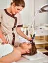 Ultrasonic facial treatment on ultrasound man face machine. Royalty Free Stock Photo