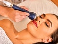 Ultrasonic facial treatment on ultrasound man face machine. Royalty Free Stock Photo