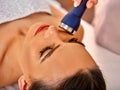 Ultrasonic facial treatment on ultrasound man face machine. Royalty Free Stock Photo