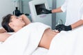 Ultrasound cavitation body contouring treatment. Woman getting anti-cellulite and anti-fat therapy on her leg in beauty