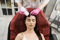 Ultrasound facial peeling using scrubber. Cosmetologist is doing ultrasonic peeling skin with skin scrubber for girl Royalty Free Stock Photo