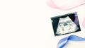 Ultrasound image pregnant baby photo. Blue, pink ribbon with ultrasound pregnancy picture on white background. Concept Royalty Free Stock Photo