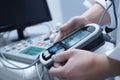 Ultrasound machine in the hands of a doctor, The doctor looks at patient pulse rate monitor closeup, AI Generated