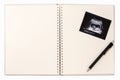 Ultrasound picture on Baby diary-blank notebook with pen Royalty Free Stock Photo