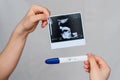 Ultrasound picture and positive pregnancy test in the hands of a girl Royalty Free Stock Photo
